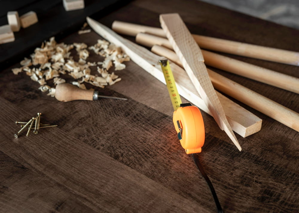 Trim boards, tape measure and chisel on a workbench
